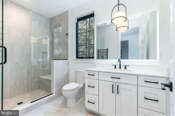 a bathroom with a toilet sink and shower