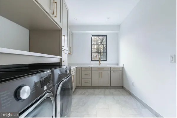 a utility room with a stove a washer and dryer