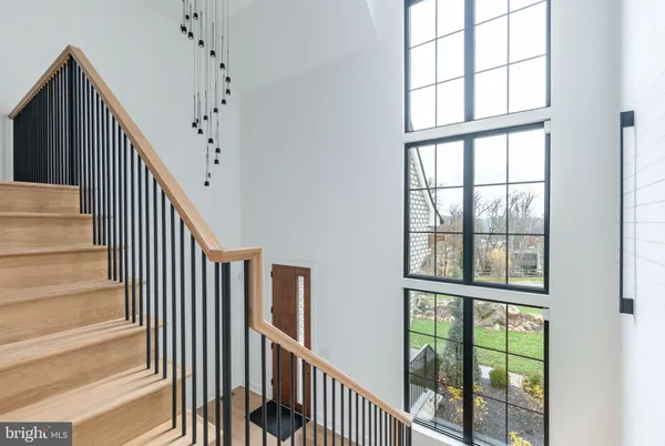 a view of staircase with wooden floor and windows