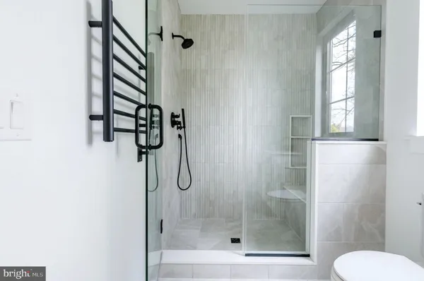a bathroom with a shower and toilet