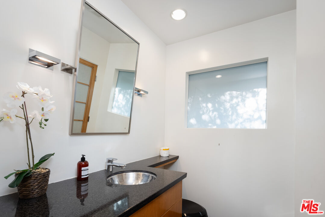1000 Stradella Road Los Angeles, CA 90077 - Photo 14 of 45 a bathroom with a sink and a mirror