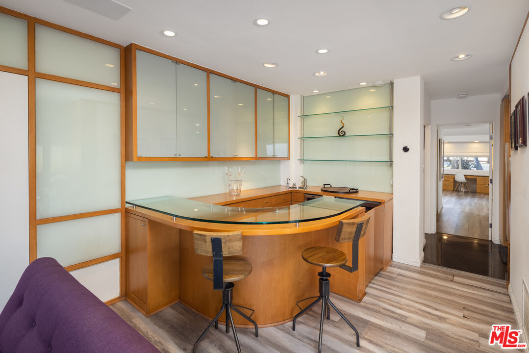 1000 Stradella Road Los Angeles, CA 90077 - Photo 16 of 45 a kitchen with stainless steel appliances granite countertop a sink and a refrigerator
