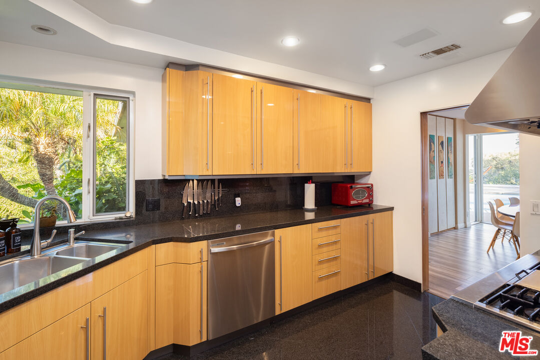 1000 Stradella Road Los Angeles, CA 90077 - Photo 20 of 45 a view of a kitchen with kitchen island granite countertop a large window and a sink