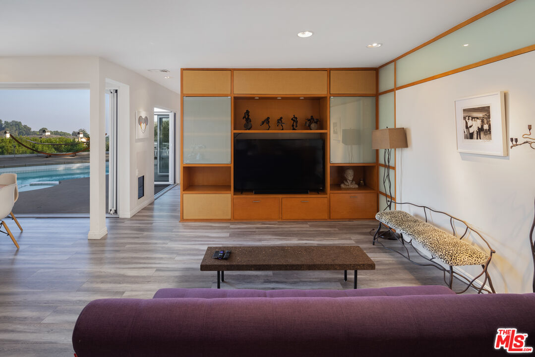 1000 Stradella Road Los Angeles, CA 90077 - Photo 21 of 45 a living room with furniture a rug and a flat screen tv