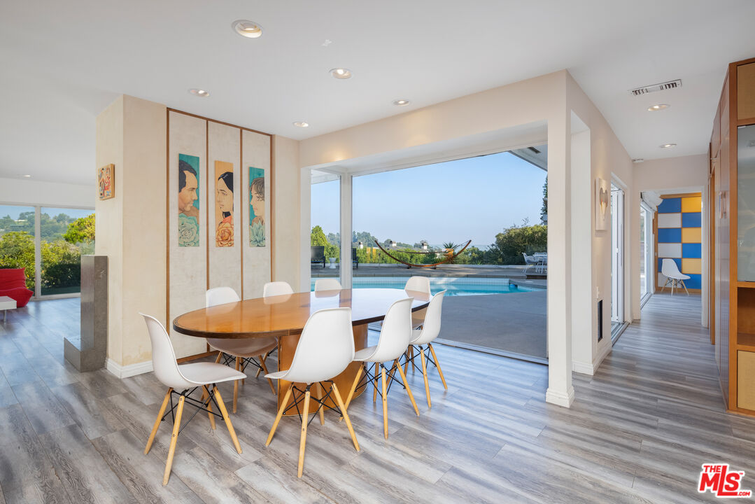 1000 Stradella Road Los Angeles, CA 90077 - Photo 23 of 45 a view of a dining room with furniture and wooden floor