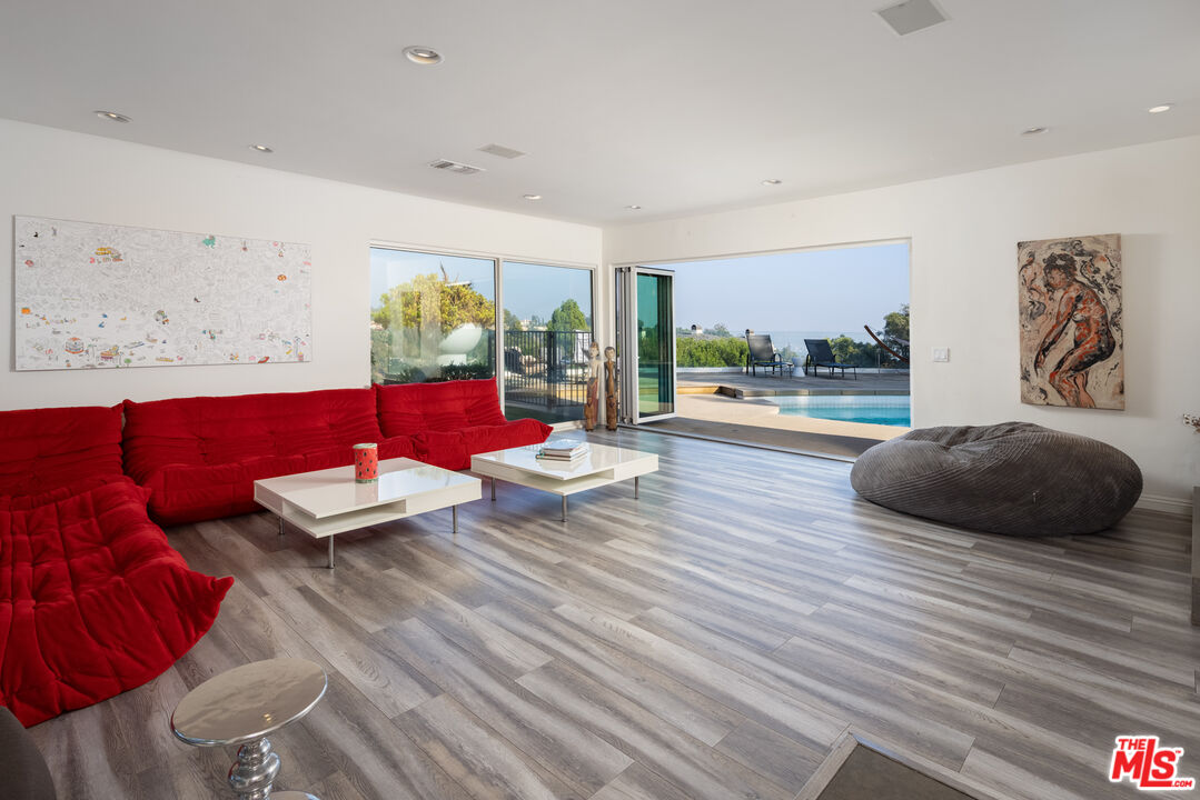 1000 Stradella Road Los Angeles, CA 90077 - Photo 25 of 45 a living room with furniture and a wooden floor