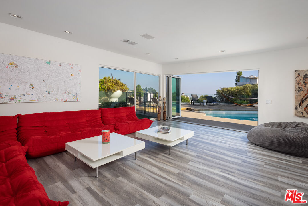 1000 Stradella Road Los Angeles, CA 90077 - Photo 26 of 45 a living room with furniture and wooden floor