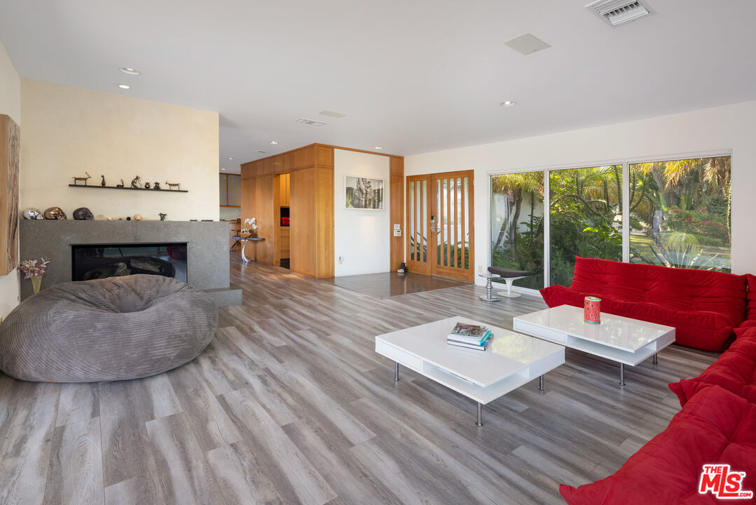 1000 Stradella Road Los Angeles, CA 90077 - Photo 27 of 45 a living room with furniture and a fireplace