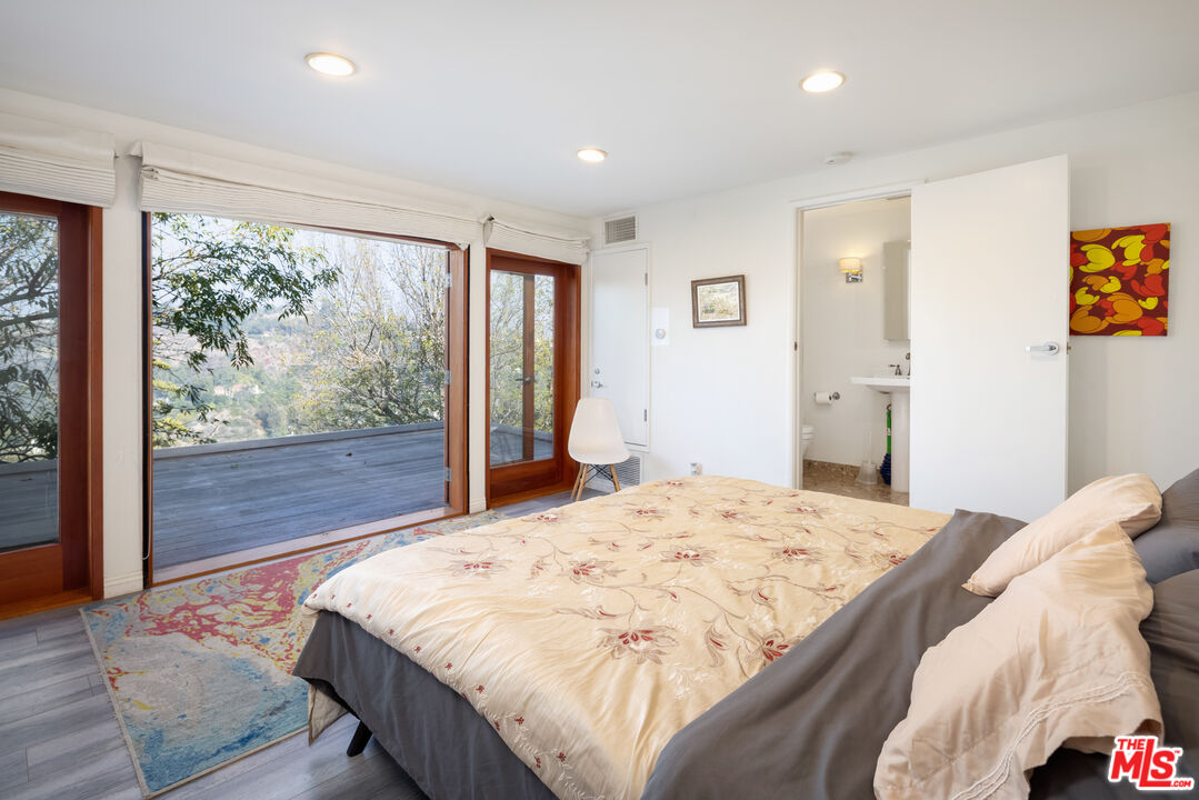 1000 Stradella Road Los Angeles, CA 90077 - Photo 4 of 45 a bed sitting in a spacious bedroom next to a window