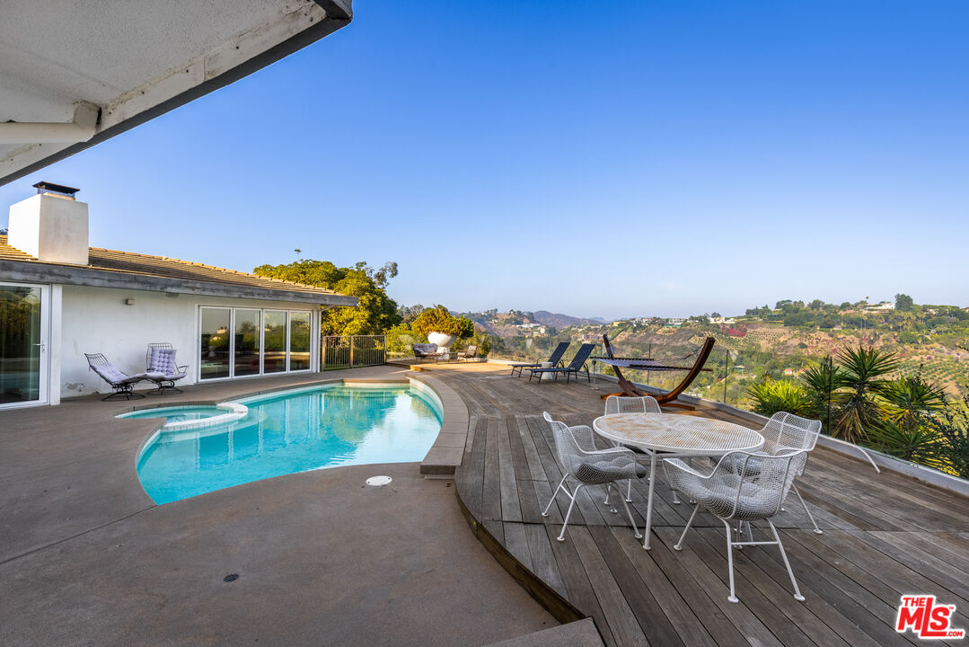 1000 Stradella Road Los Angeles, CA 90077 - Photo 40 of 45 a view of a swimming pool with a lounge chair