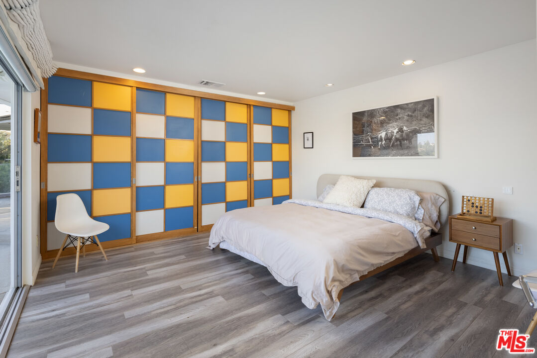 1000 Stradella Road Los Angeles, CA 90077 - Photo 6 of 45 a spacious bedroom with a bed and a chair