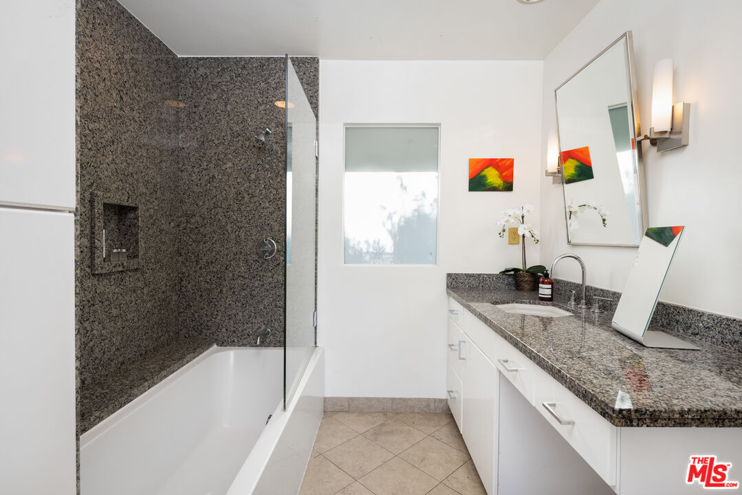 1000 Stradella Road Los Angeles, CA 90077 - Photo 8 of 45 a bathroom with a granite countertop sink and a bathtub