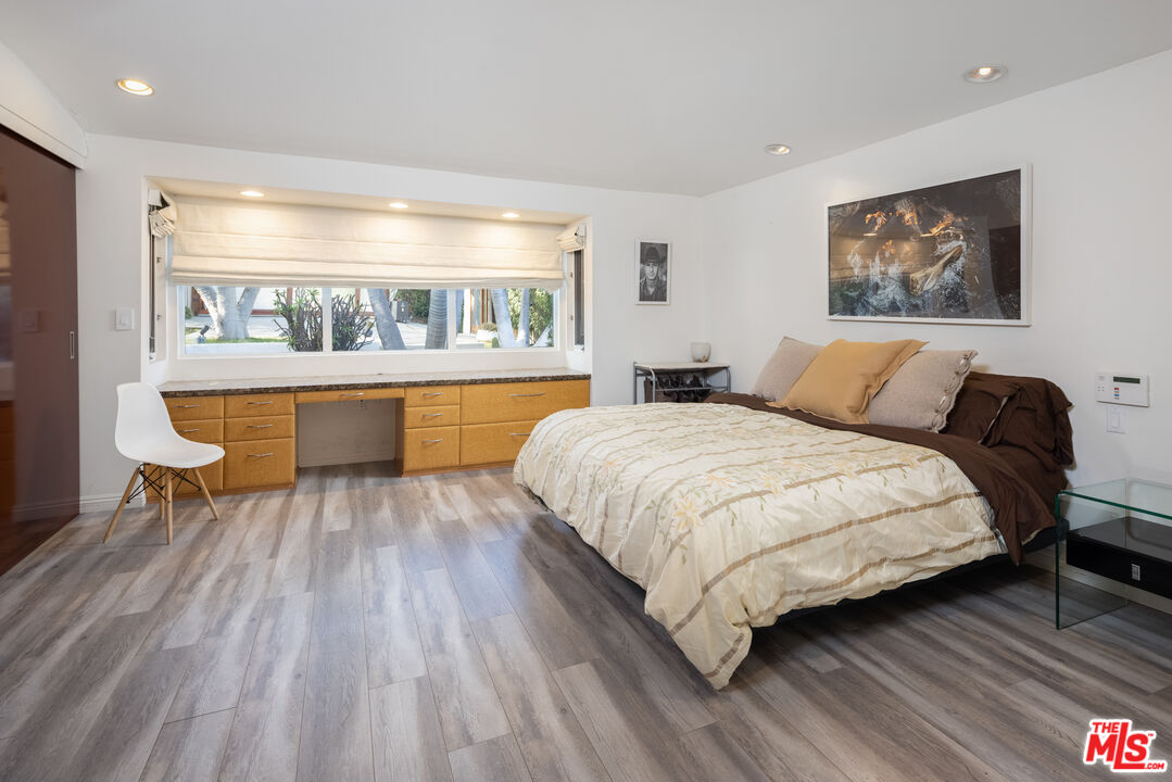 1000 Stradella Road Los Angeles, CA 90077 - Photo 10 of 45 a large bedroom with a bed and wooden floor