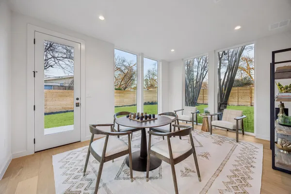 a dining room with furniture and a rug