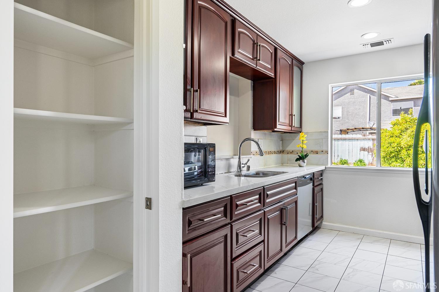 117 Malcolm Drive Richmond, CA 94801 - Photo 15 of 37 a kitchen with stainless steel appliances granite countertop a sink and a stove