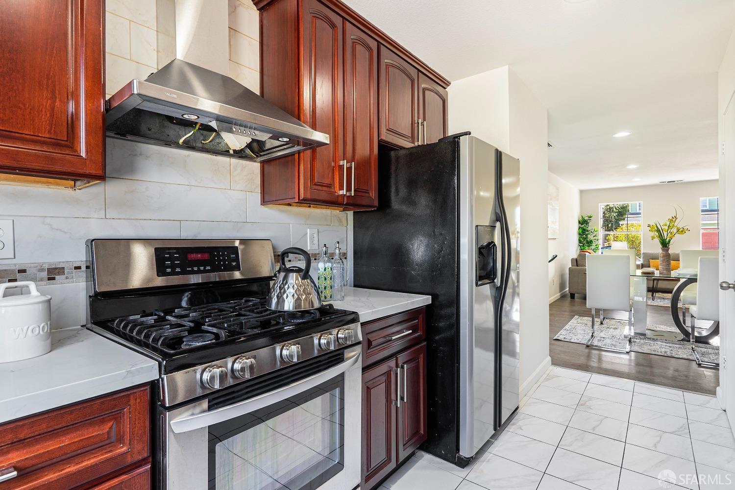 117 Malcolm Drive Richmond, CA 94801 - Photo 16 of 37 a kitchen with stainless steel appliances granite countertop a stove a refrigerator and a refrigerator