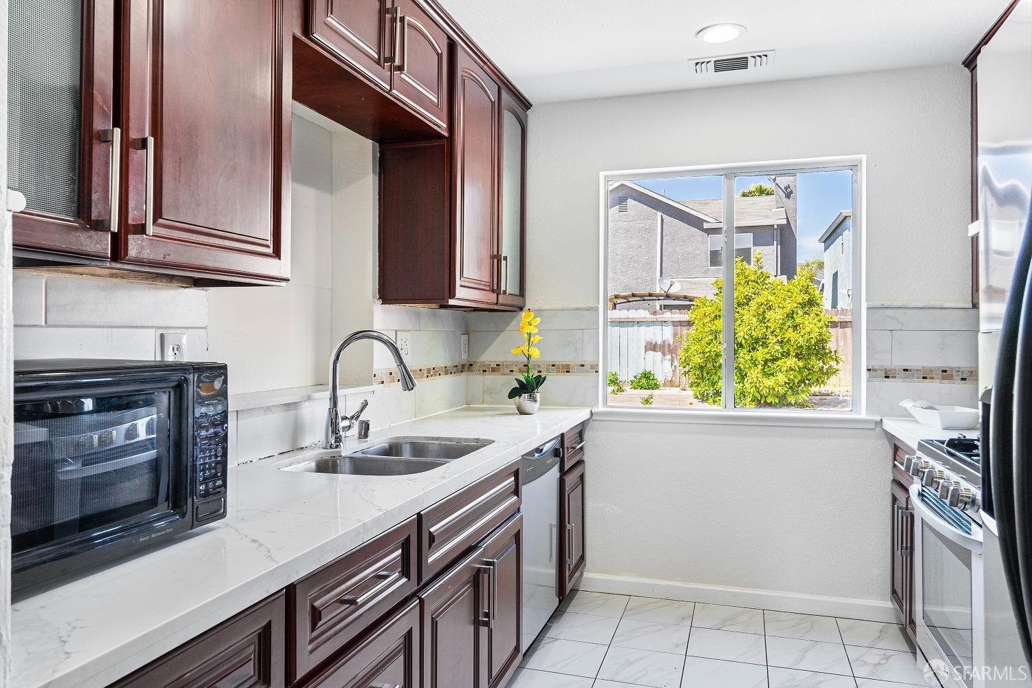 117 Malcolm Drive Richmond, CA 94801 - Photo 17 of 37 a kitchen with stainless steel appliances a sink a stove and cabinets