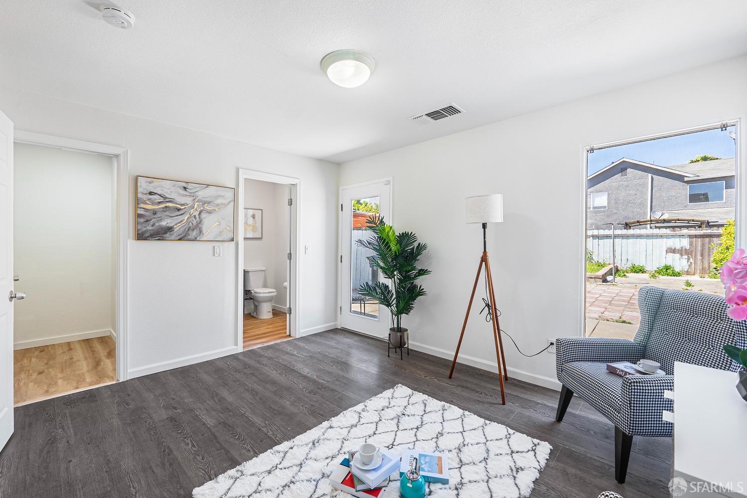 117 Malcolm Drive Richmond, CA 94801 - Photo 18 of 37 a living room with furniture and a wooden floor