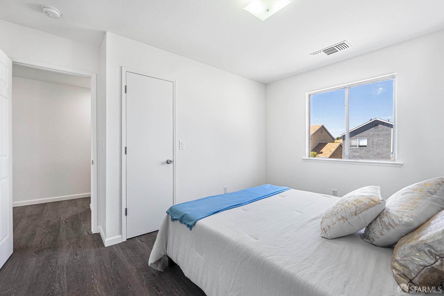 117 Malcolm Drive Richmond, CA 94801 - Photo 25 of 37 a bedroom with a bed and wooden floor