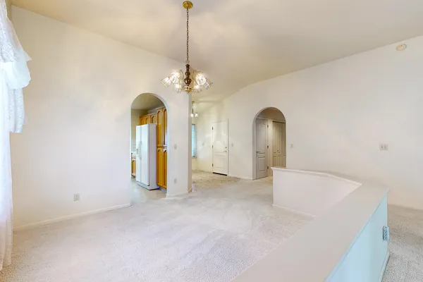 a kitchen with stainless steel appliances granite countertop a refrigerator a sink dishwasher a stove with wooden cabinets and floors