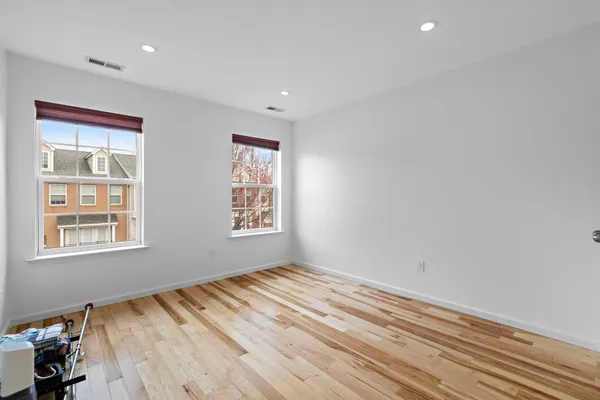 a view of room with window and hardwood floor