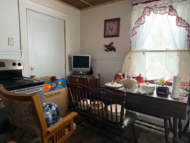 a view of a dining room with furniture and a window