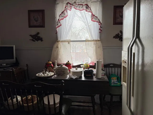a view of a dining room with furniture and a window