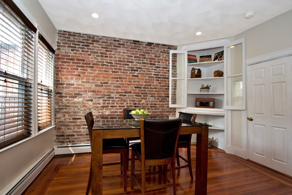 a dining room with a wooden table and chairs