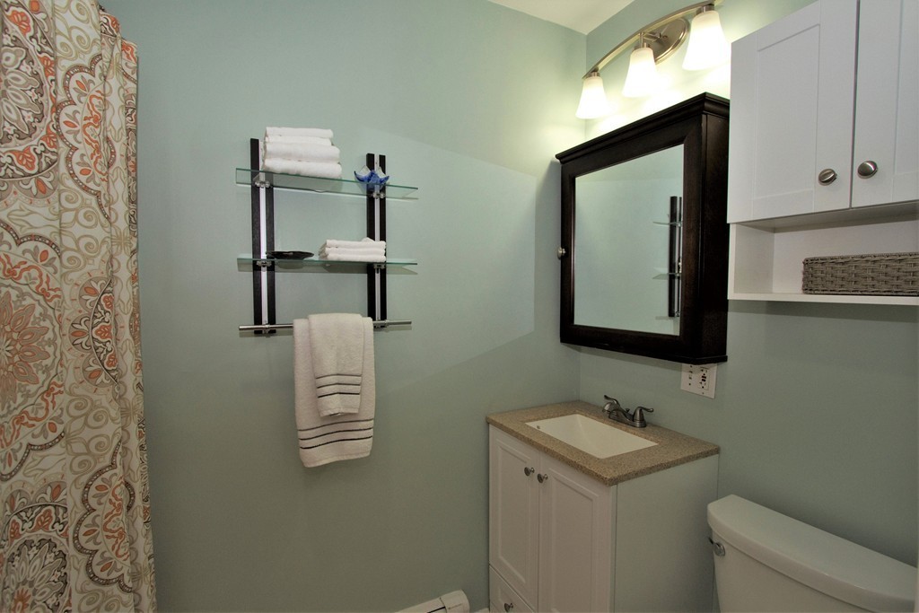 25 Sullivan Street, Unit 3 Boston, MA 02129 - Photo 11 of 13 a bathroom with a sink a toilet and mirror
