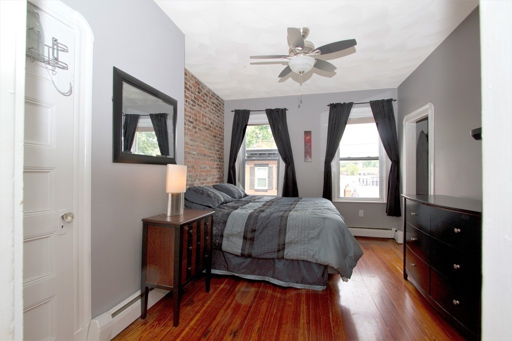 25 Sullivan Street, Unit 3 Boston, MA 02129 - Photo 3 of 13 a living room with a bed furniture and a window