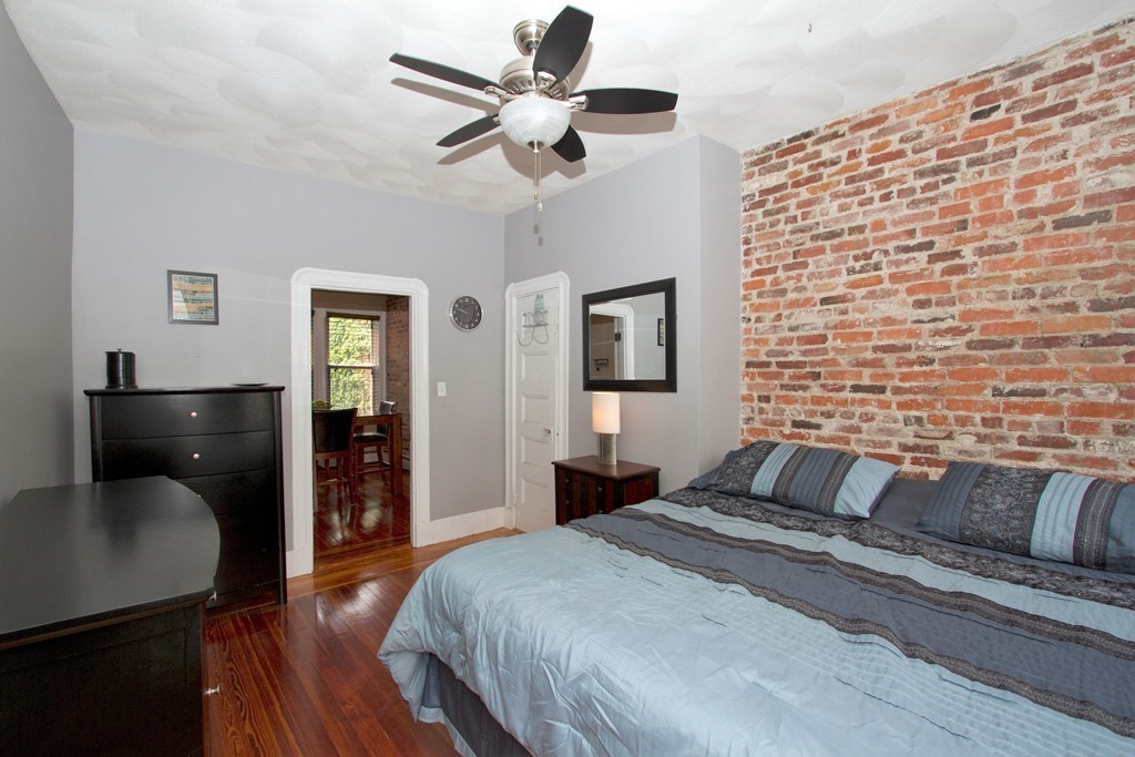 25 Sullivan Street, Unit 3 Boston, MA 02129 - Photo 4 of 13 a bedroom with a bed and wooden floor