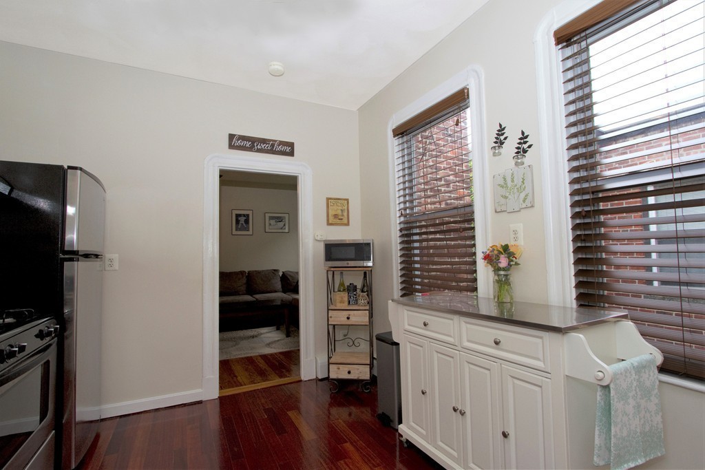25 Sullivan Street, Unit 3 Boston, MA 02129 - Photo 8 of 13 a hallway with cabinets and wooden floor