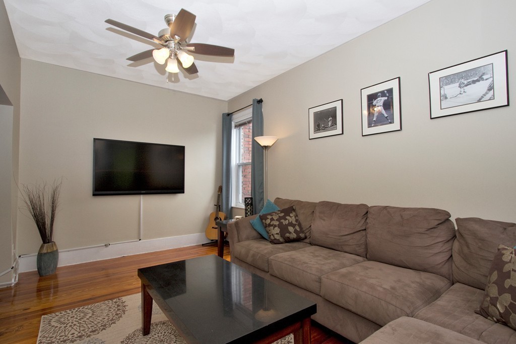 25 Sullivan Street, Unit 3 Boston, MA 02129 - Photo 10 of 13 a living room with furniture and a flat screen tv