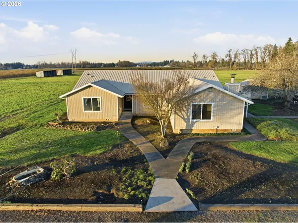 a view of a house with backyard and lake view