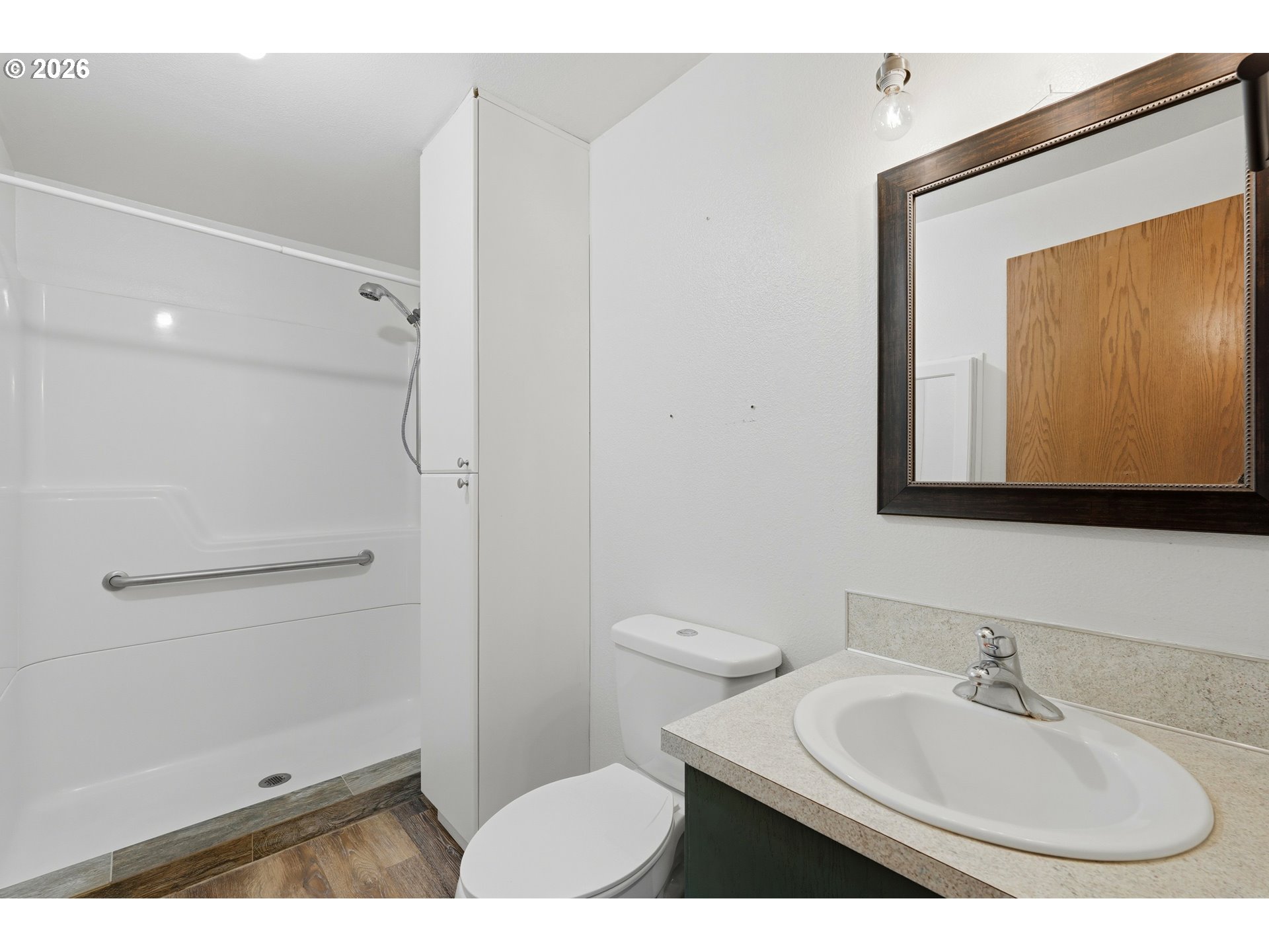 8949 South Gribble Road Canby, OR 97013 - Photo 23 of 36 a bathroom with a sink a toilet and a mirror