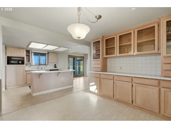 a kitchen with a sink and a stove top oven