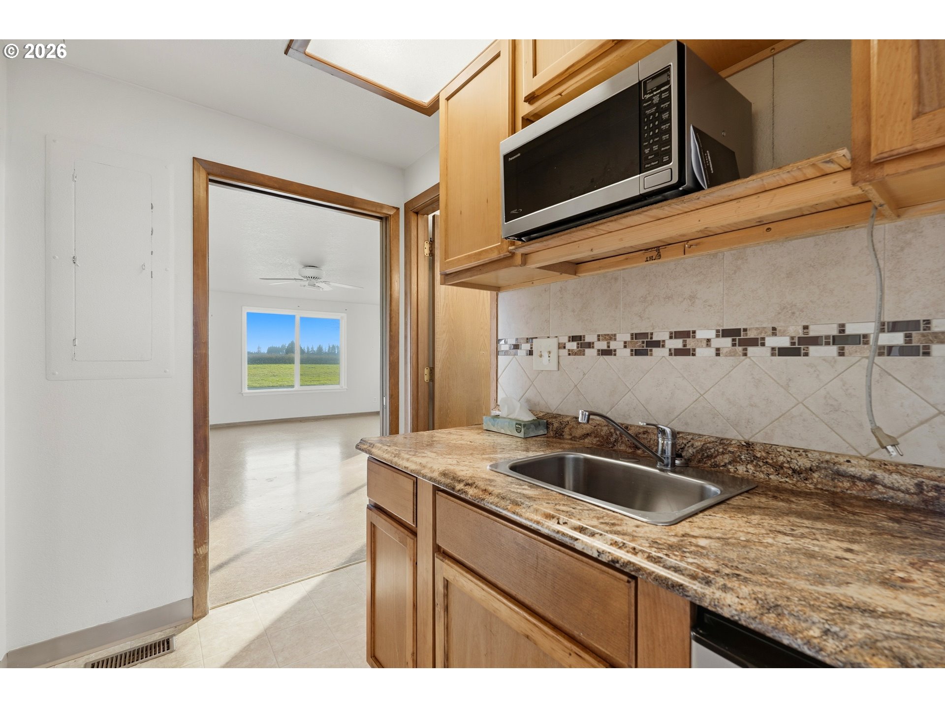 8949 South Gribble Road Canby, OR 97013 - Photo 9 of 36 a kitchen with a sink and a microwave