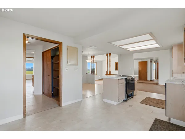 a view of a room with wooden floor and a window