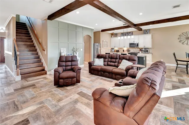 a kitchen with stainless steel appliances a stove refrigerator sink and cabinets