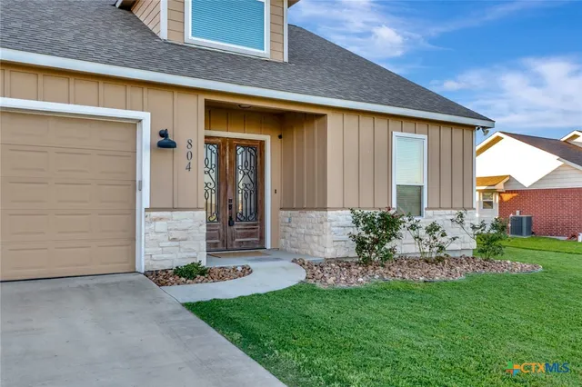 a front view of a house with garden