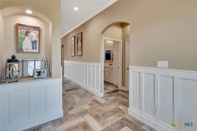 a living room with furniture a flat screen tv and a window