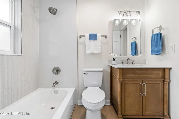 a bathroom with a sink a toilet and bathtub