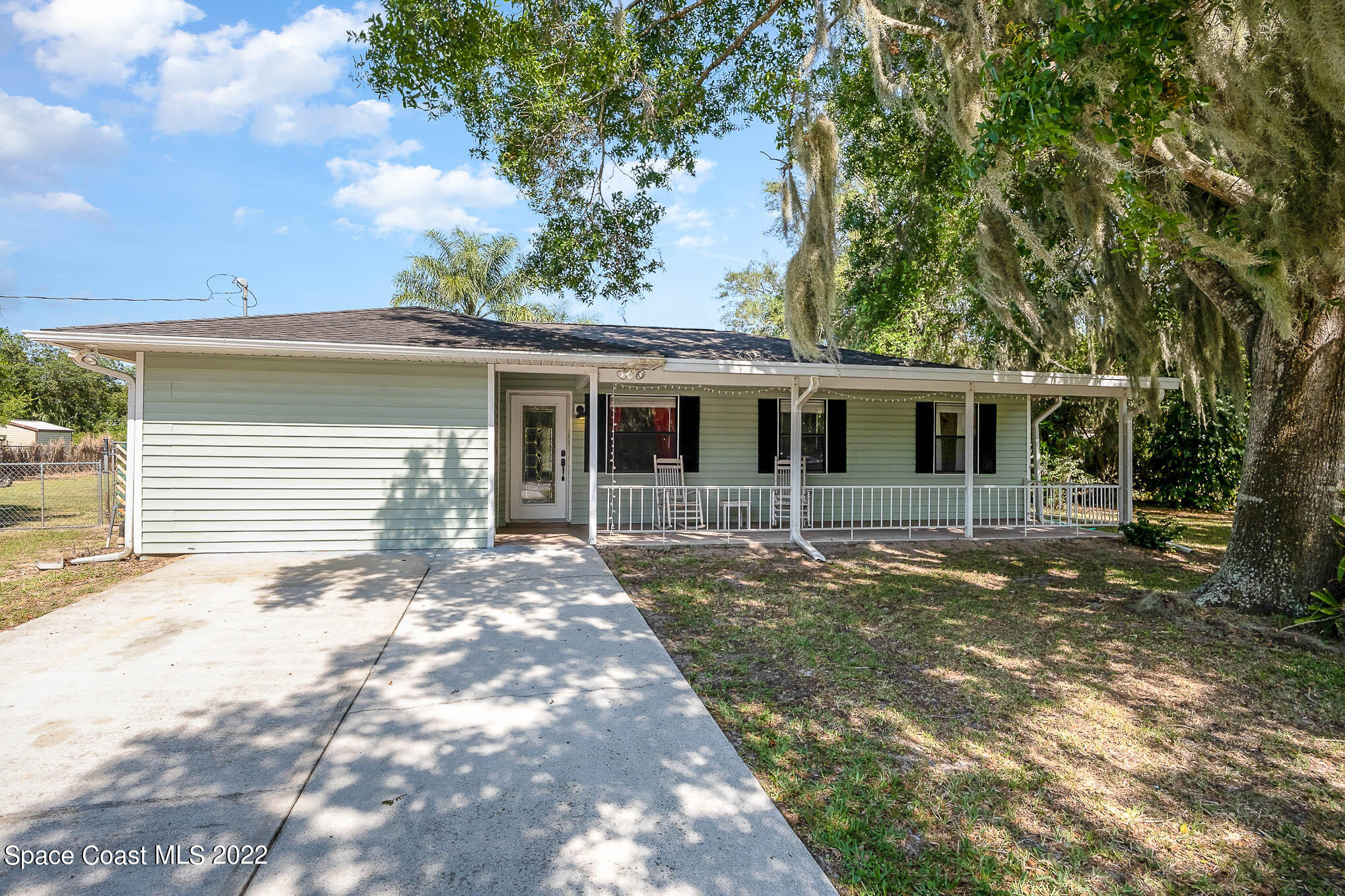 3453 Brevard Road Mims, FL 32754 - Photo 1 of 22 a front view of a house with a garden