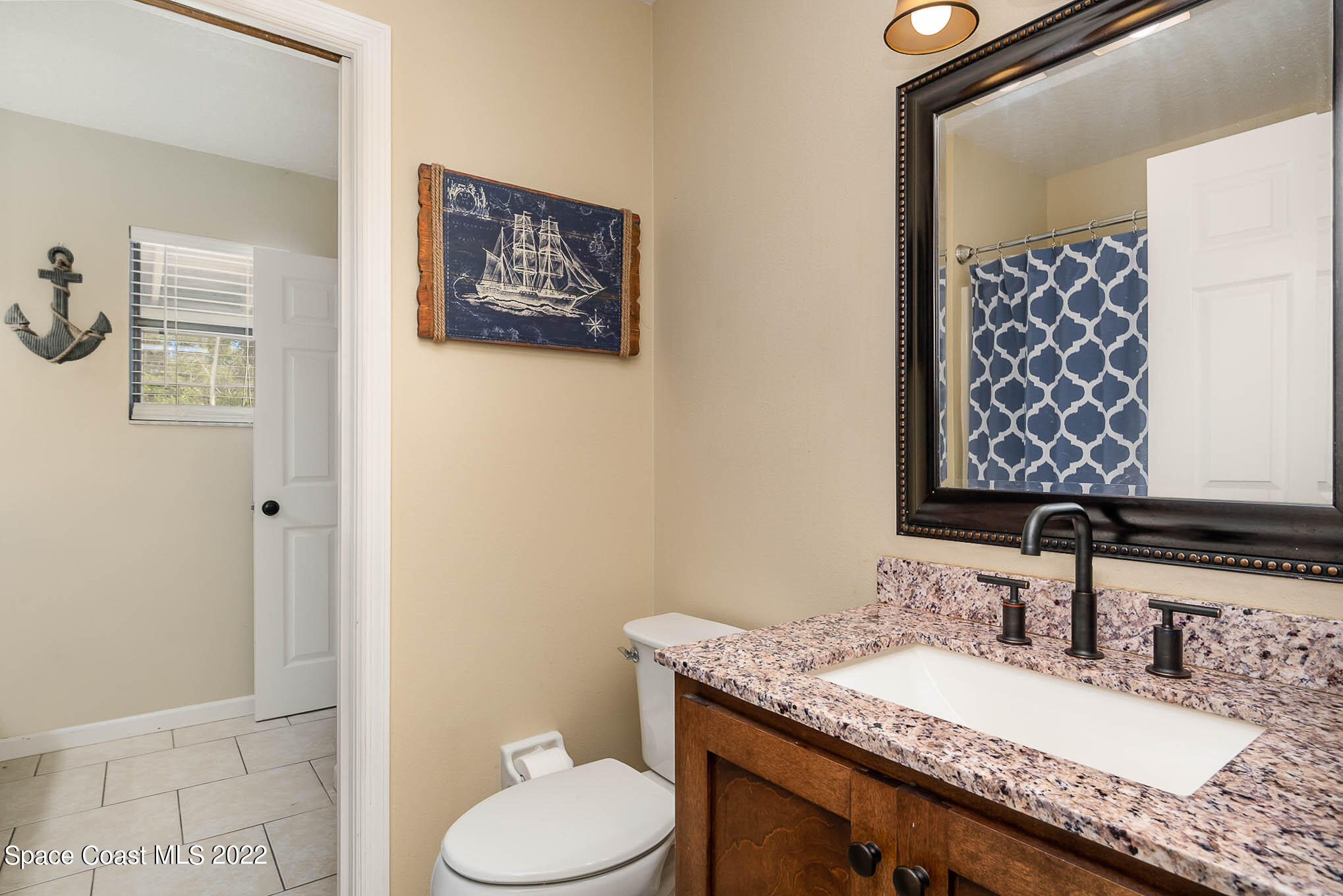 3453 Brevard Road Mims, FL 32754 - Photo 11 of 22 a bathroom with a granite countertop sink mirror vanity and toilet
