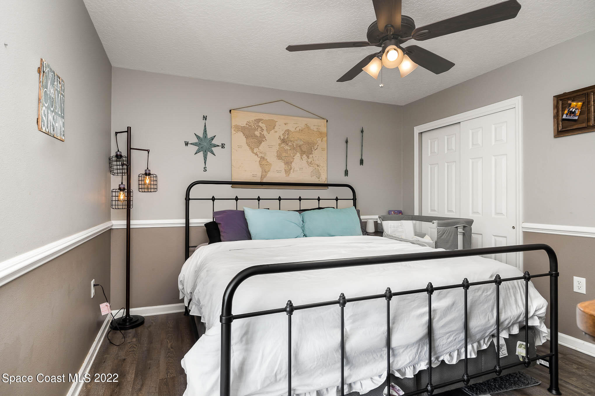 3453 Brevard Road Mims, FL 32754 - Photo 12 of 22 a bedroom with a bed and a chandelier