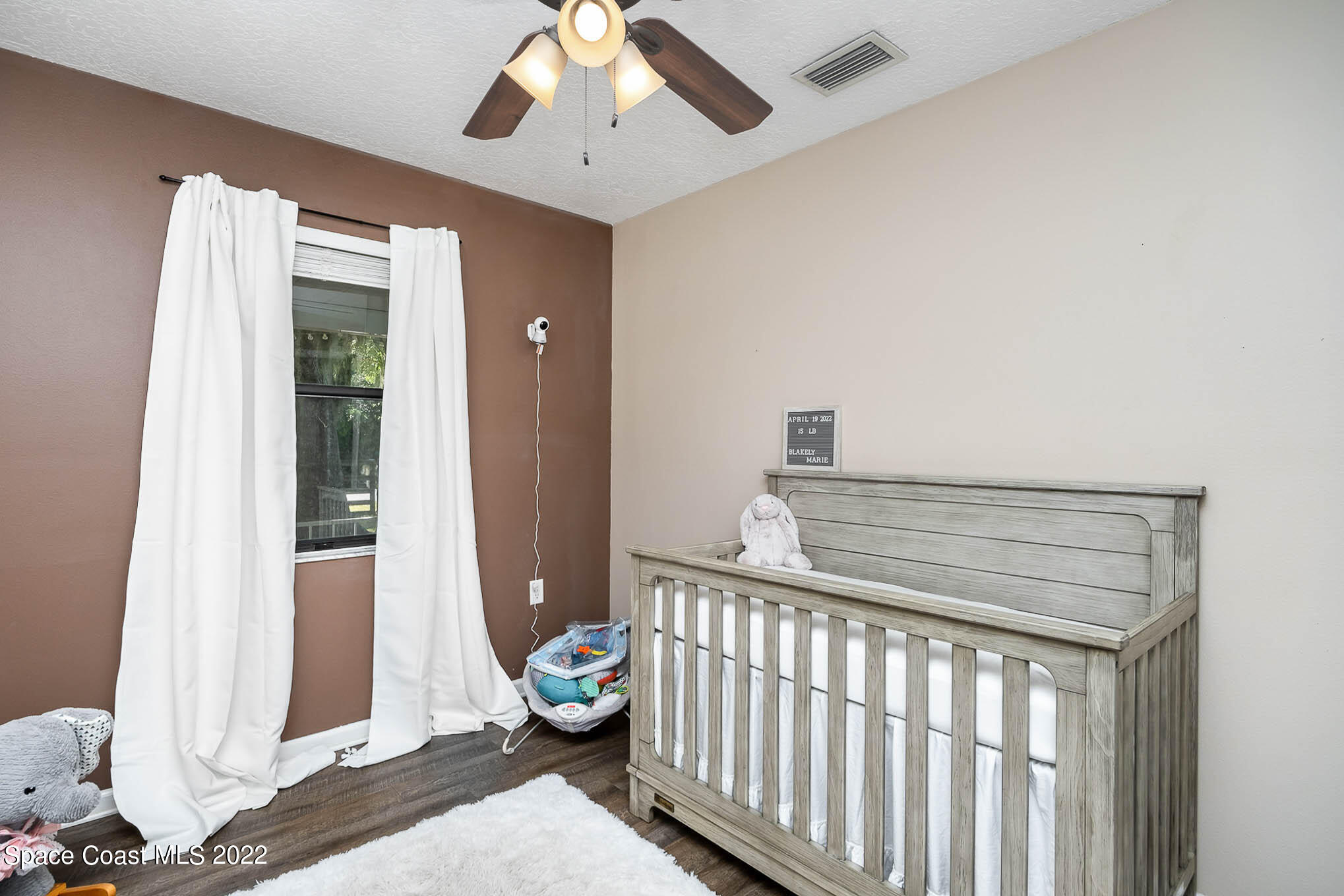 3453 Brevard Road Mims, FL 32754 - Photo 15 of 22 a bedroom with a bed and a window