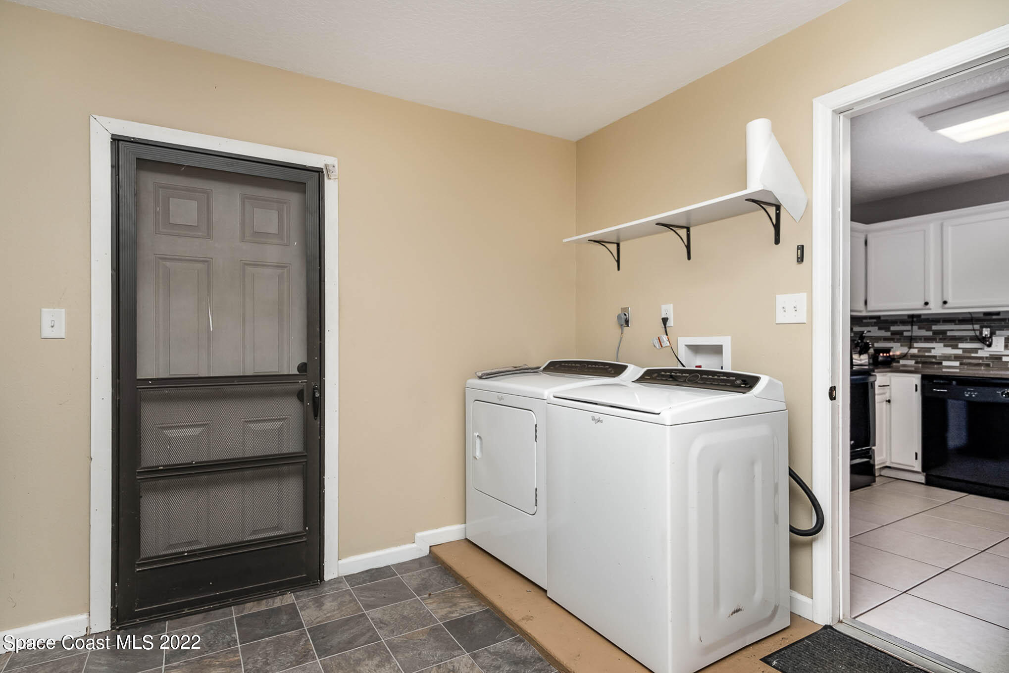 3453 Brevard Road Mims, FL 32754 - Photo 17 of 22 a utility room with cabinets washer and dryer