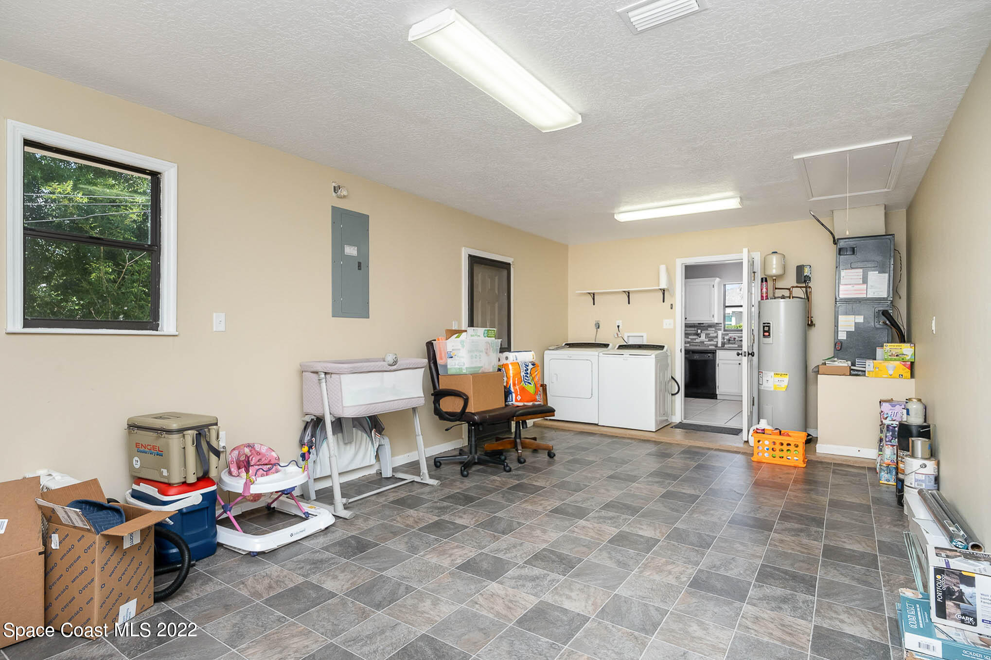 3453 Brevard Road Mims, FL 32754 - Photo 18 of 22 a living room with furniture and a chandelier