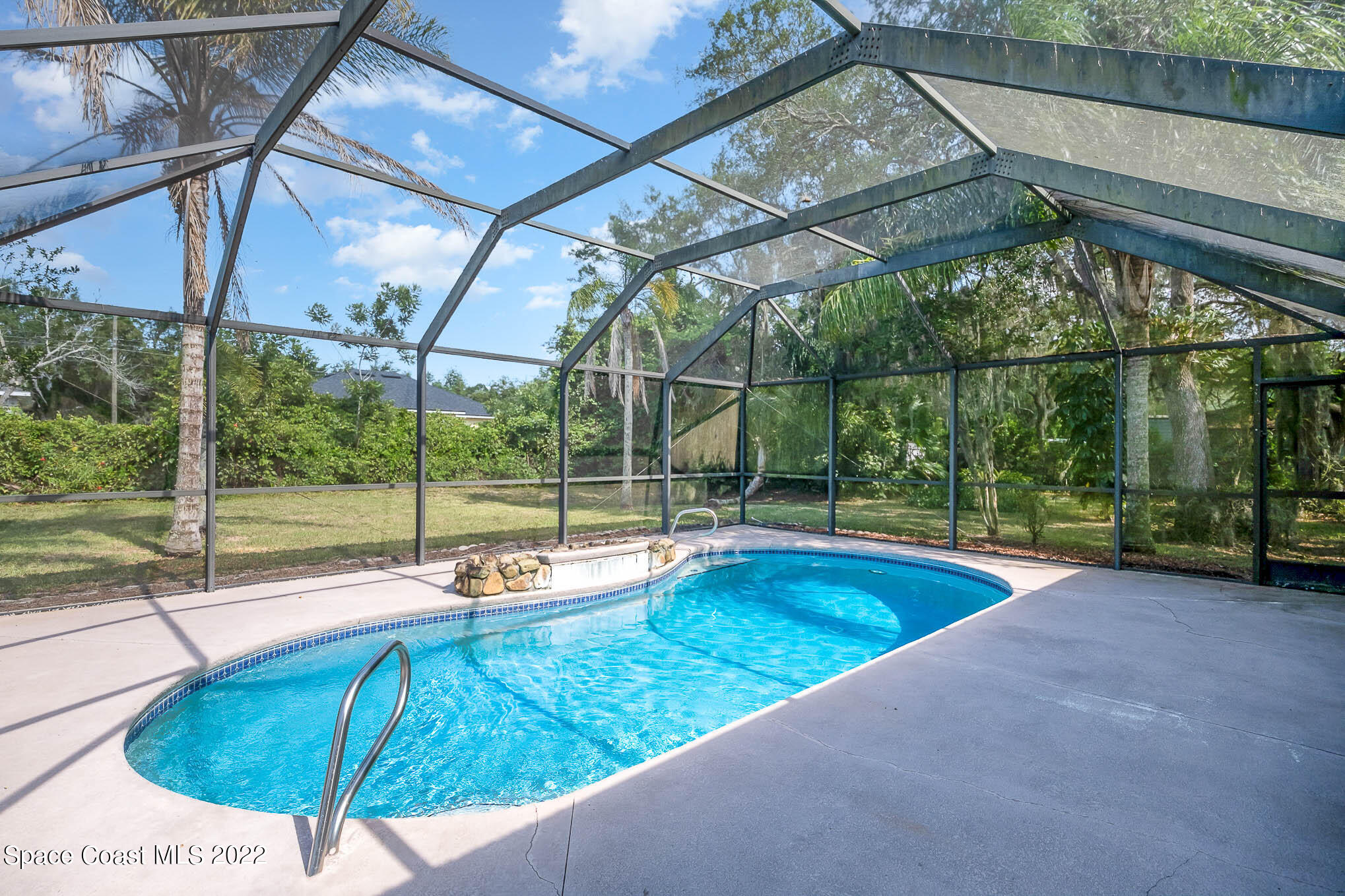 3453 Brevard Road Mims, FL 32754 - Photo 20 of 22 a view of a backyard with a swimming pool