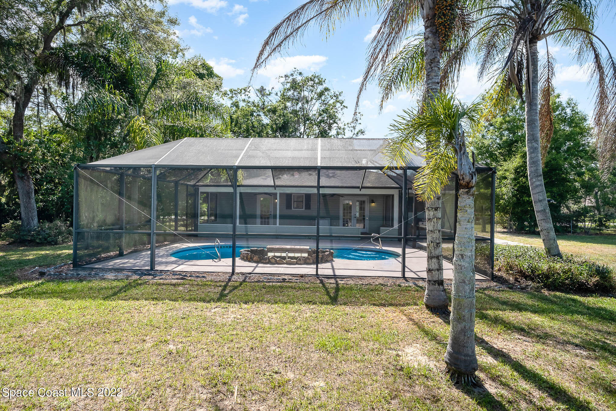 3453 Brevard Road Mims, FL 32754 - Photo 22 of 22 a house with swimming pool in front of it